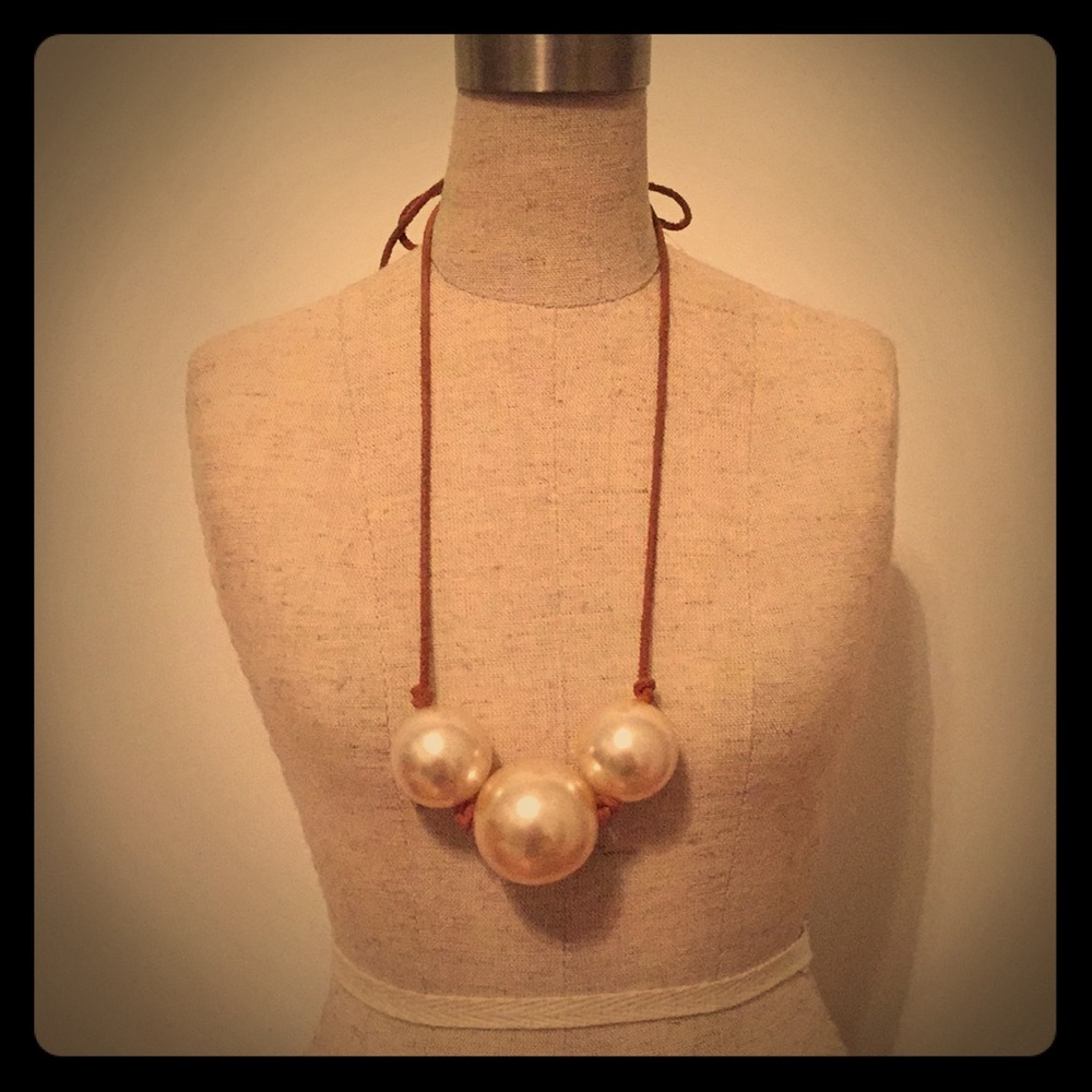 Necklace with brown leather tie in the back chain